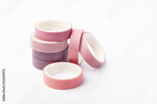 Pink and purple rolls of washi tape on a white background photo