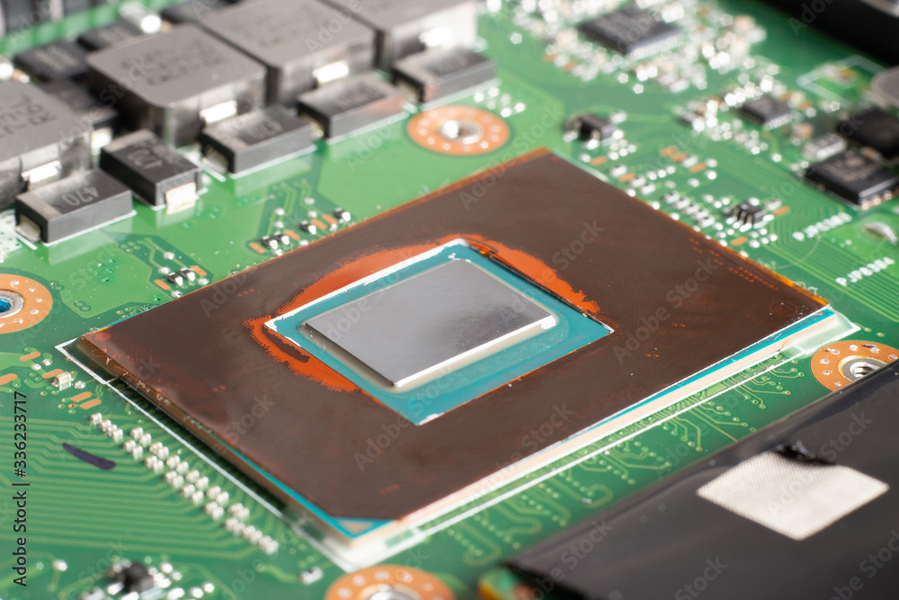 Thermal grease on a processor on a computer motherboard Thermal grease on a processor on a computer motherboard