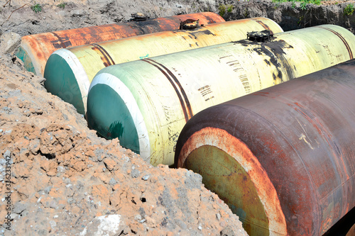 Large tanks in the excavated quarry for storage of petroleum products. Background