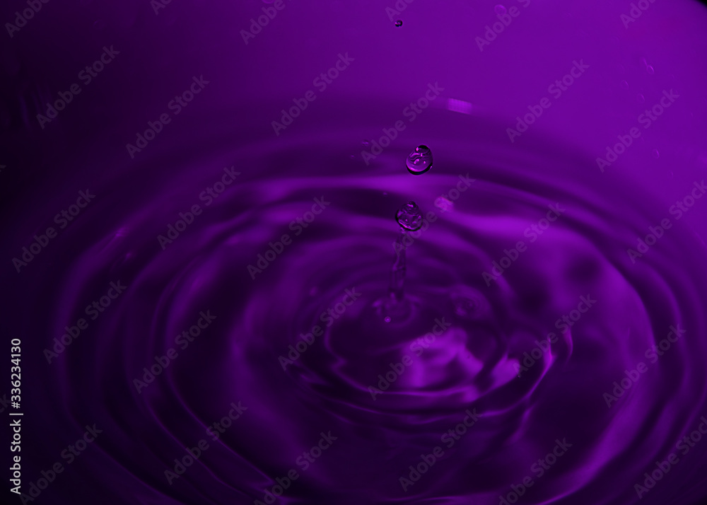 Drop of water on white bowl, violet tones Drop of water on white bowl, violet tones
