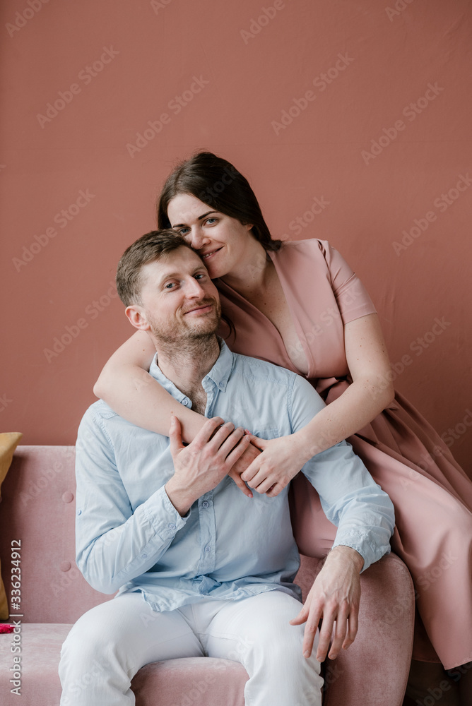 Happy couple hugging on sofa Happy couple hugging on sofa