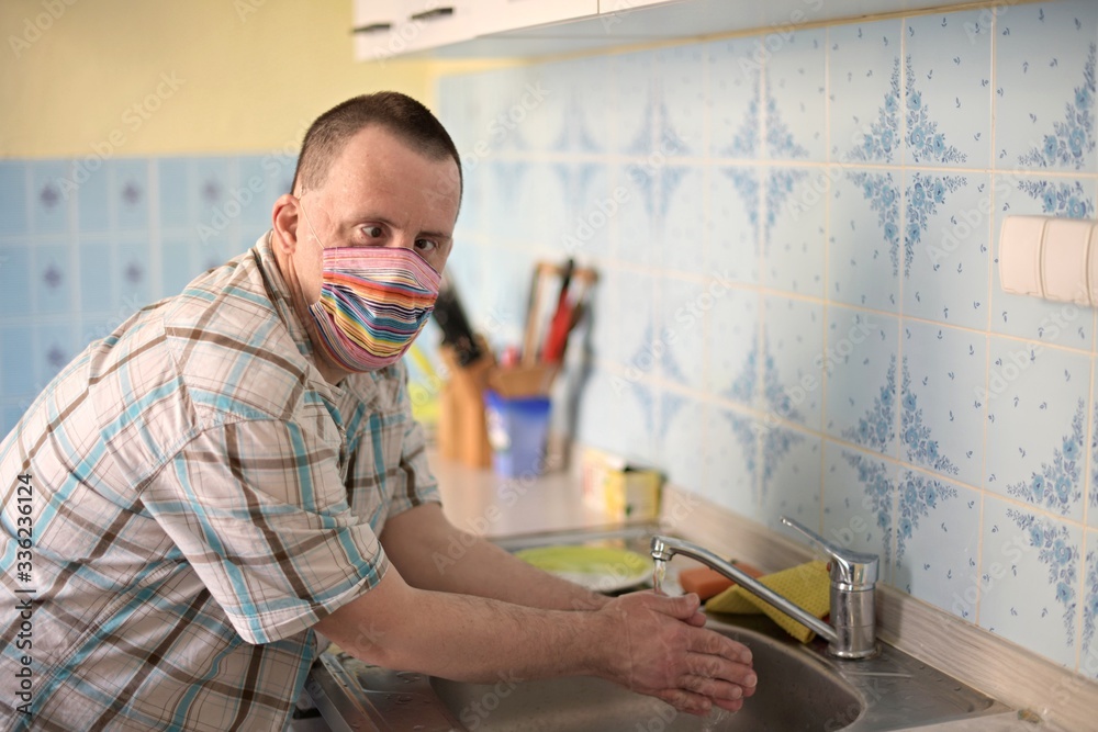 man with down syndrome washing hands