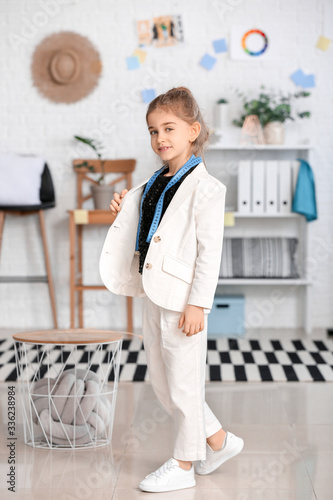 Cute little dressmaker in a...