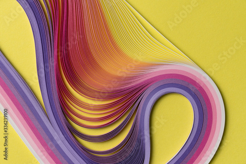 Multi colored quilling paper lying on colorful paper photo