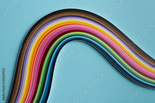 Multi colored quilling paper lying on colorful paper