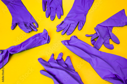 bunch of purple gloves thrown on yellow background, pattern