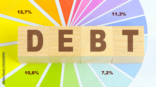 Obraz na plátně debt inscription on wooden blocks graphic background