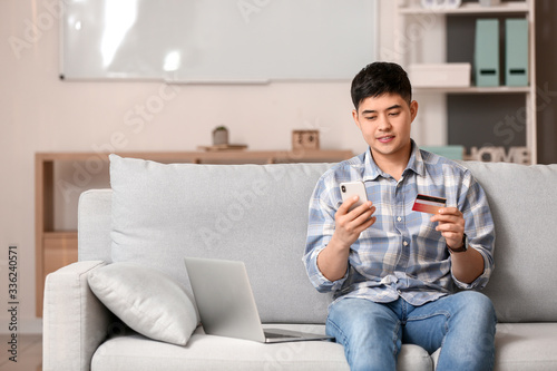 Asian man shopping online a...