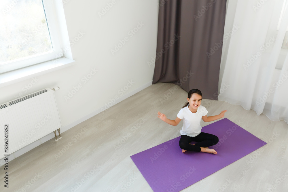 little girl practices yoga at home little girl practices yoga at home