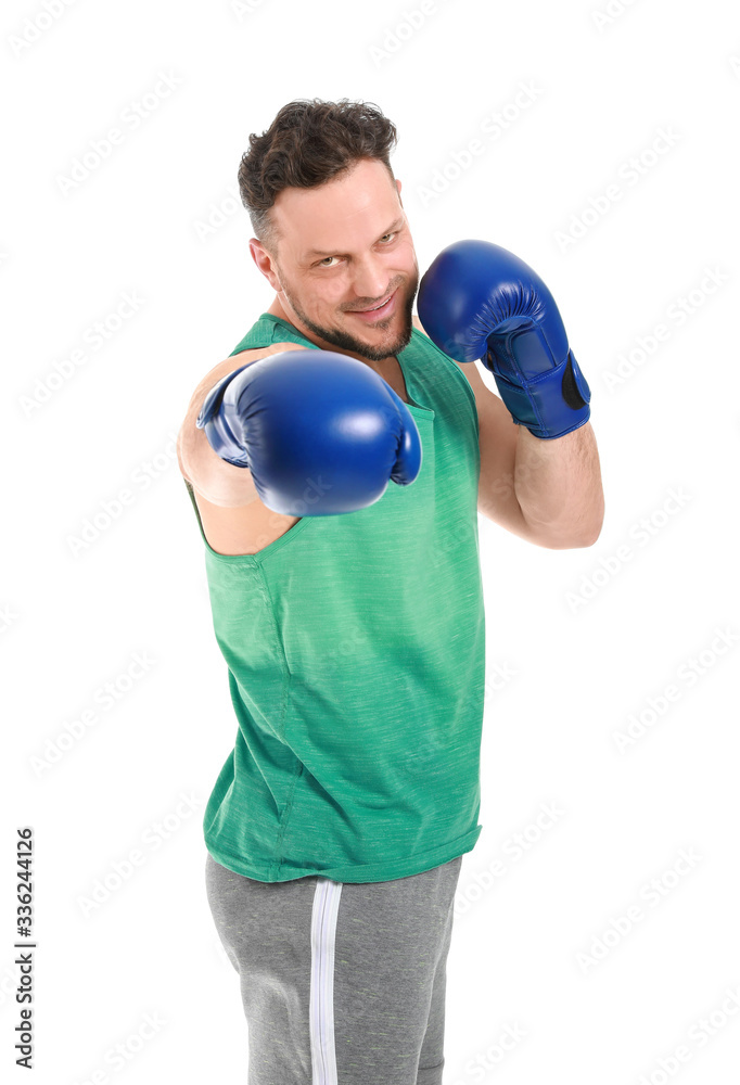 Sporty man with boxing gloves on white background
