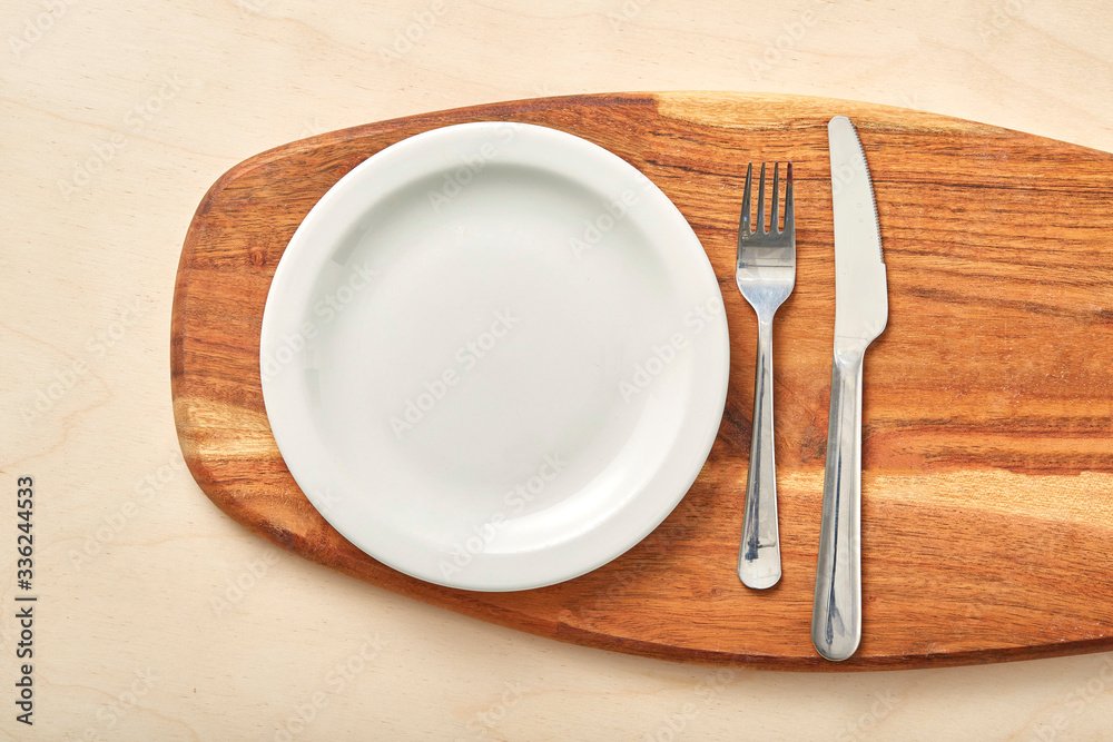 Empty plate and chopping board on table. Top view. Empty plate and chopping board on table. Top view.