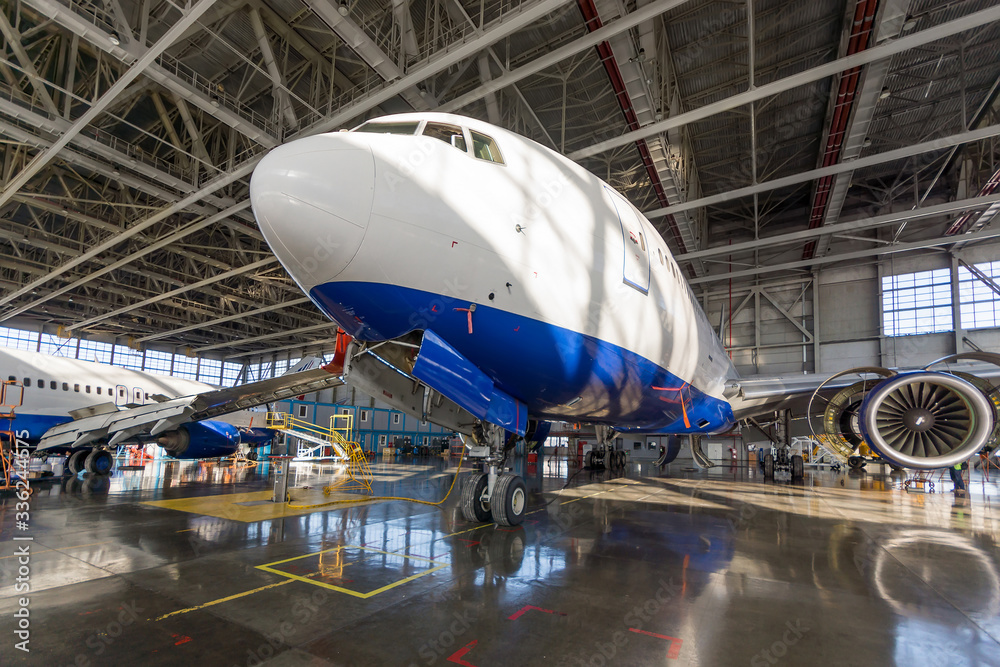Passenger aircraft in the hangar. Maintenance preparation Passenger aircraft in the hangar. Maintenance preparation