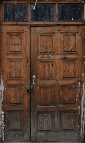 Old wooden brown door, brown boards, vintage decrepit texture