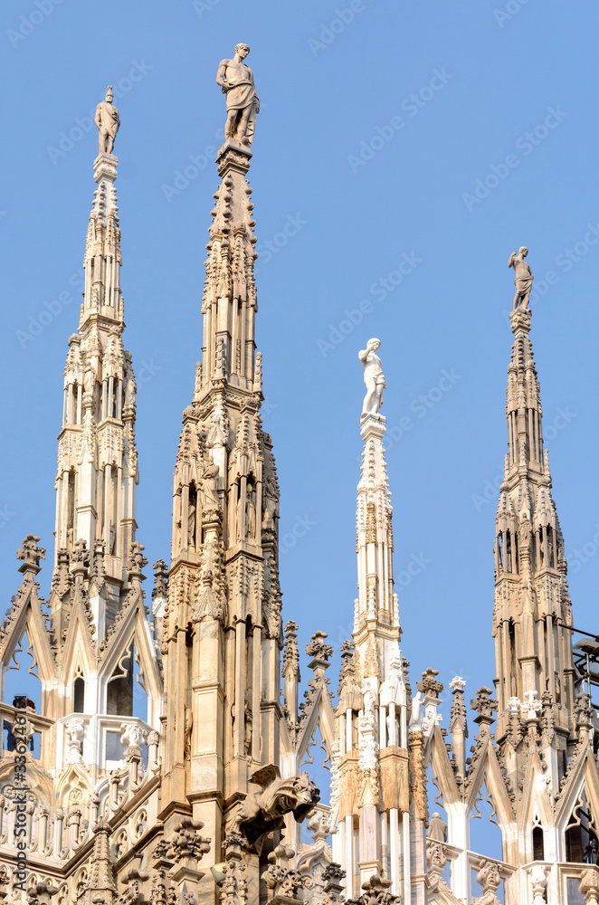 Cathedral of the Nativity of the Virgin Mary in Milan. Cathedral of white marble. The Late Gothic building contains many spiers and sculptures, marble peaked towers and columns.