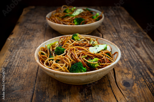 Bowls of Japanese?soba?noodles with?bok?choy, broccolies, soy sauce and black sesame photo