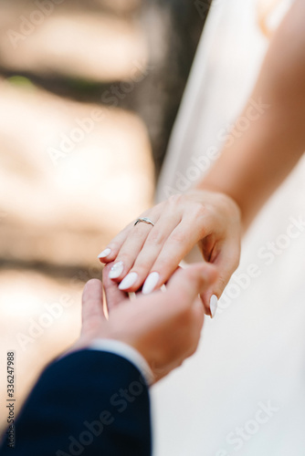 the bride and groom tenderly hold hands between them love and relationships