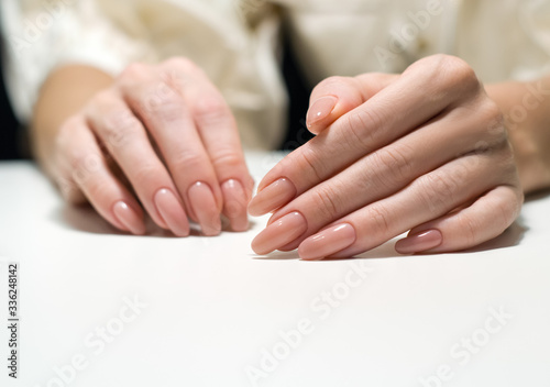 woman hands with french manicure macro white background