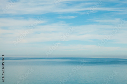 blue ocean waves and sky clouds summer background © zakalinka