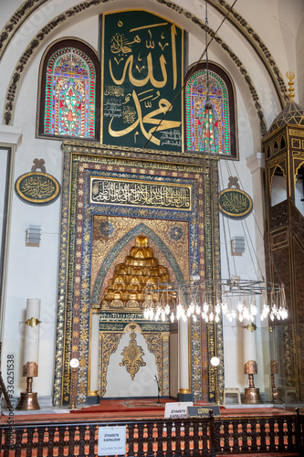 Bursa, Turkey - February 23, 2020: Islamic calligraphic writings between windows on wall of historical Ulu Cami (Grand Mosque) in Bursa.