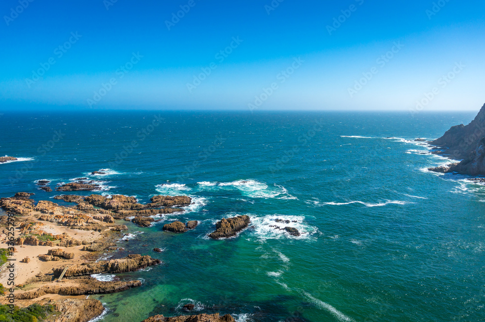 Open ocean seascape with rocky cliffs coastline
