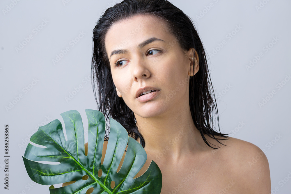 Beauty Woman with natural green palm leaf portrait. Fashion, beauty, make-up, cosmetics. Beauty Woman with natural green palm leaf portrait. Fashion, beauty, make-up, cosmetics.