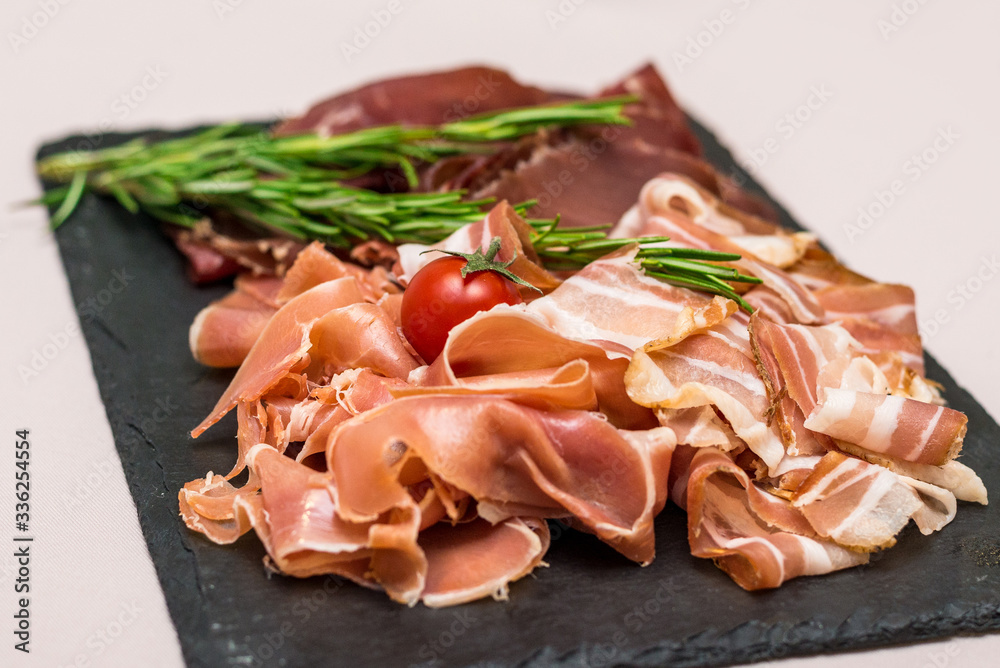 Assorted meat slices of different varieties for the whole frame. horizontal frame Assorted meat slices of different varieties for the whole frame. horizontal frame