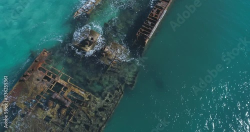 Close 4k aerial fly by video of underwater ship wreck in beautiful green blue ocean 