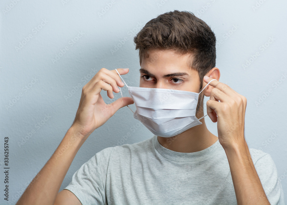 Young hispanic man wearing protection face mask against coronavirus concept Young hispanic man wearing protection face mask against coronavirus concept