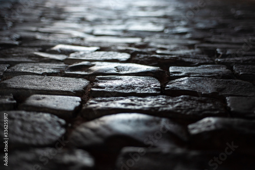  background texture old road from large old stones leaves in perspective