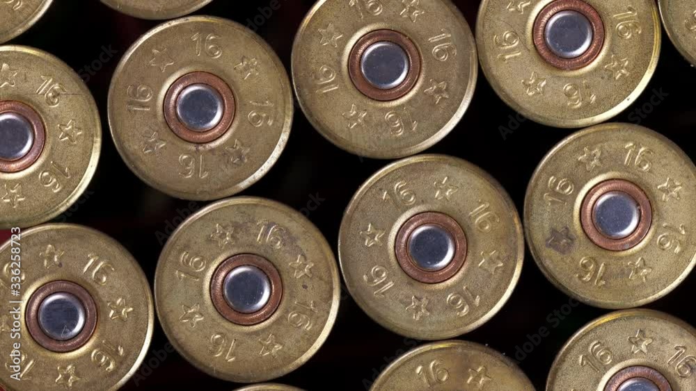 Closeup weathered green ammo cartridges for modern firearm stacked together in rows Closeup weathered green ammo cartridges for modern firearm stacked together in rows