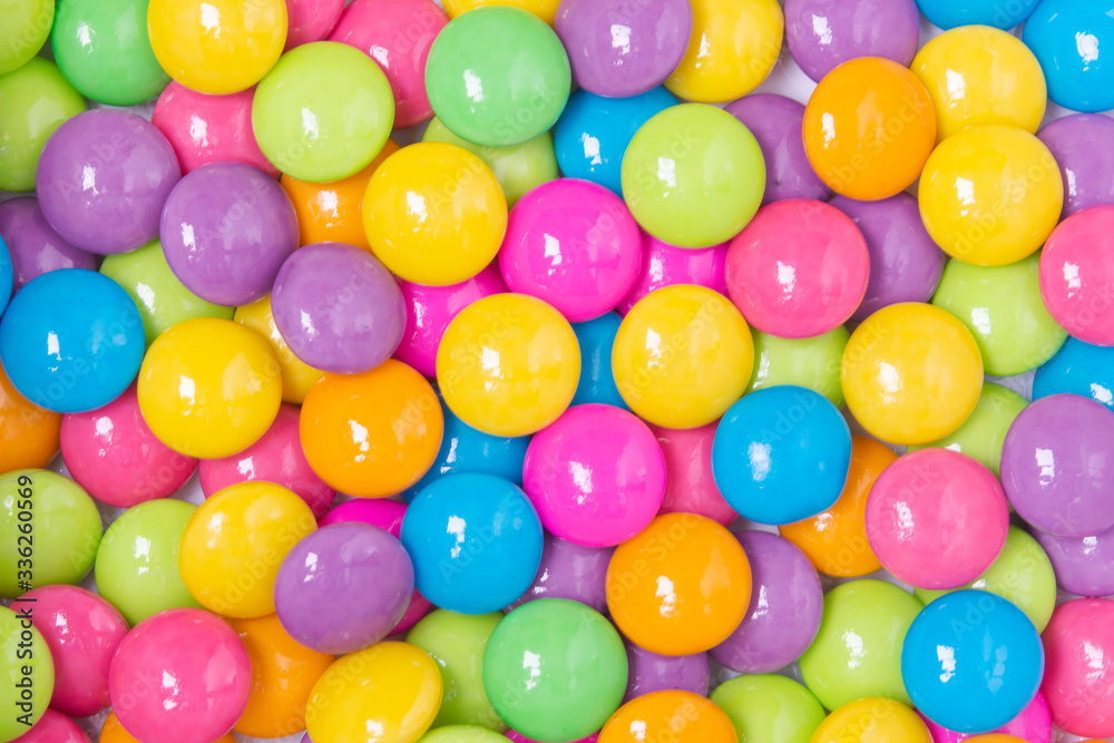 Pile of colorful sweet candy chocolates coated on white paper. colourful collection background. Pile of colorful sweet candy chocolates coated on white paper. colourful collection background.