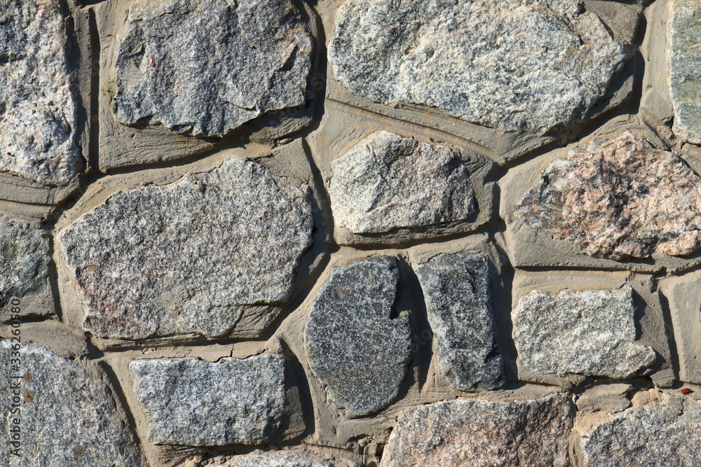 Fototapeta premium Stone wall as a background.Decorative natural stone. Natural decoration of the facade of the house, building