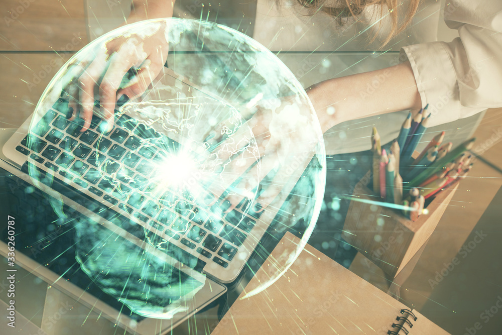 Double exposure of woman hands typing on computer and business theme hologram drawing. Success concept.