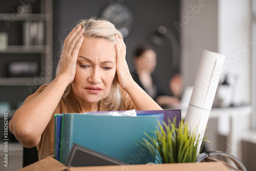 Sad fired mature woman with...