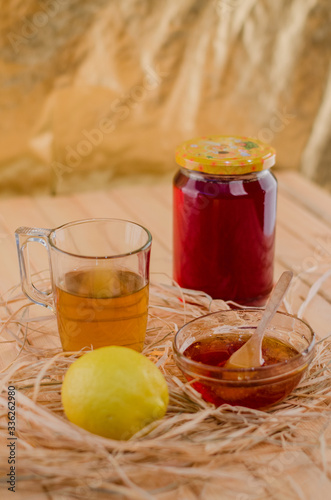 Honey in a jar and tea on a wooden table