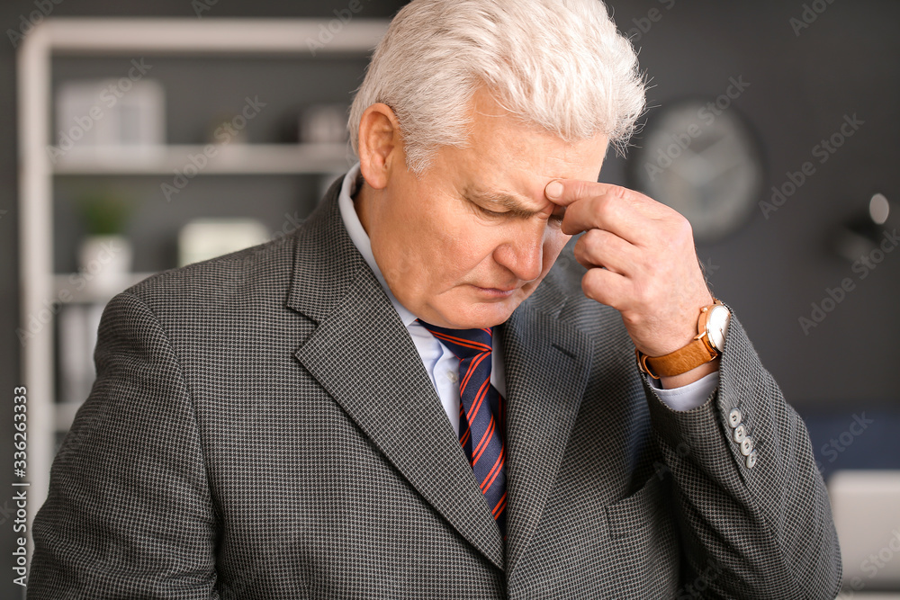 Sad fired mature man in office