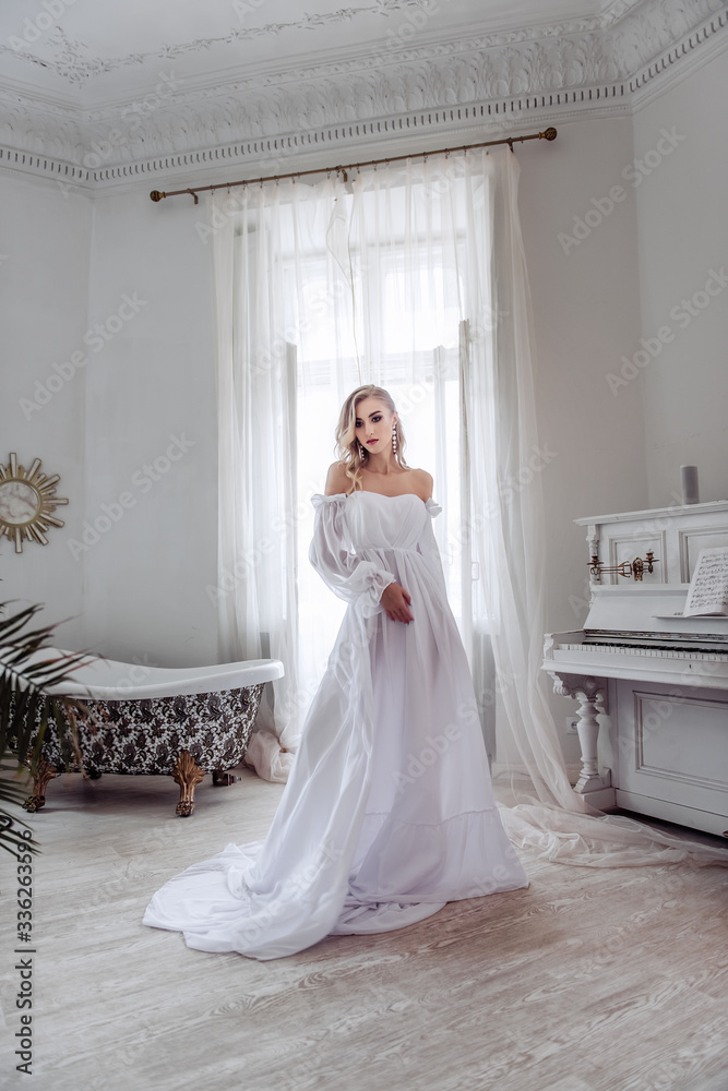 A beautiful bride in a long white dress is circling the room. An important day for any girl. The modern image of a bride. A beautiful bride in a long white dress is circling the room. An important day for any girl. The modern image of a bride.