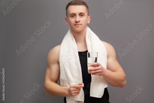 Trainer takes a pill of amino acids after training