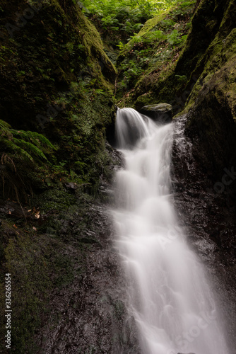 Waterfall on levada Faja do Rodrigues hiking trail. North of Madeira island. Long exposure. 