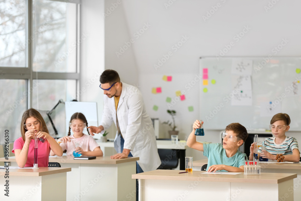 Teacher conducting chemistry lesson in classroom Teacher conducting chemistry lesson in classroom