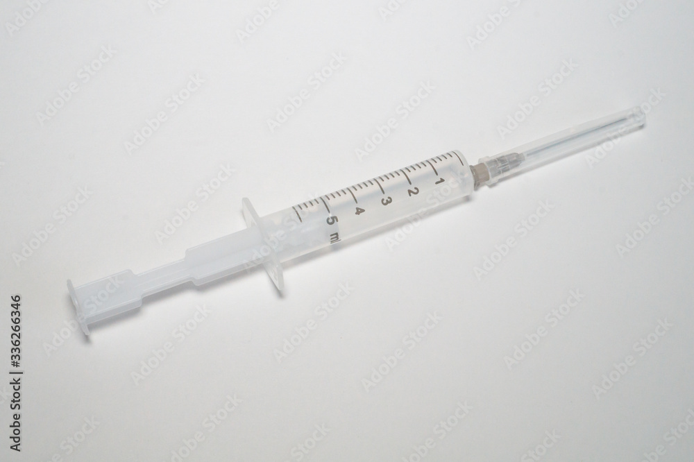 Disposable plastic syringe on a white background Disposable plastic syringe on a white background