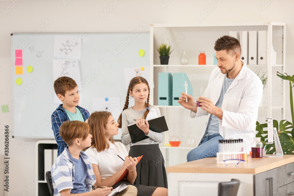 Teacher conducting chemistry lesson in classroom Teacher conducting chemistry lesson in classroom
