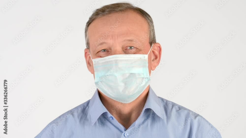 Closeup portrait of an elderly man in a medical mask Isolated on a white background. Health care and medical concept. virus protection Closeup portrait of an elderly man in a medical mask Isolated on a white background. Health care and medical concept. virus protection