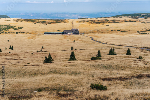 View of the Krkonose National Park (Giant  mountains) and the famous mountain hut Lucni bouda. Czech Republic highest mountain range. photo