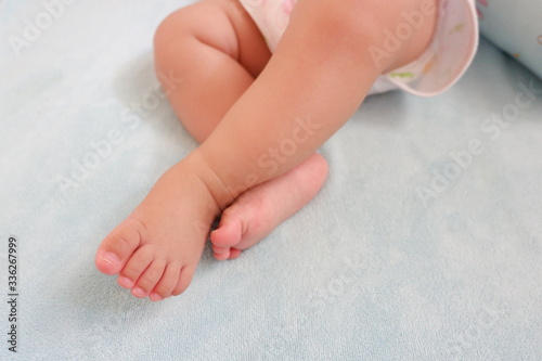 Baby's feet on blue background