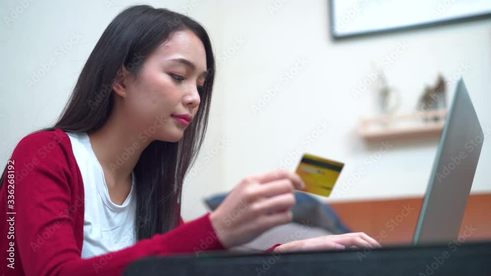 Close-up young beautiful Asian female happy and use credit card to buying online Close-up young beautiful Asian female happy and use credit card to buying online