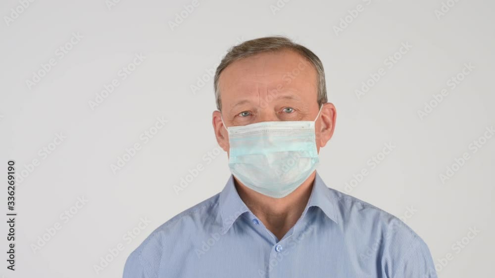 Elderly man in a medical mask Isolated on a white background. Health care and medical concept. virus protection Elderly man in a medical mask Isolated on a white background. Health care and medical concept. virus protection