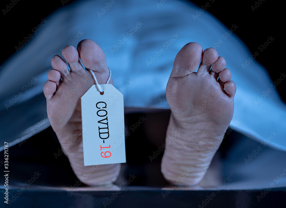 Strong image of feet with toe tag of a dead body coronavirus victim