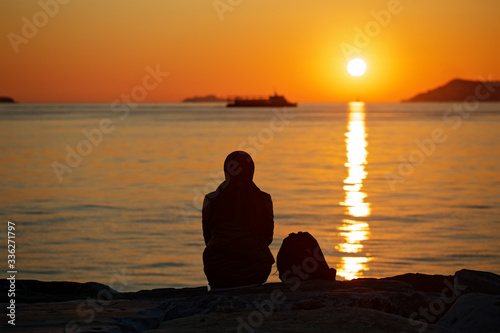 Silhouette of a muslim woman watching the sea of Marmara sunset in Maltepe  Istanbul  Turkey