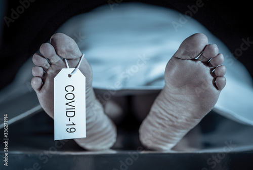 Strong image of feet with toe tag of a dead body coronavirus victim. COVID-19 deaths Health alert